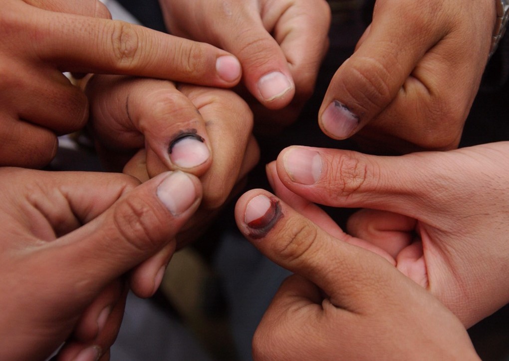 Jeroen Oerlemans. Voters show their thumbs, which earlier that day had been dipped in a supposedly indelible ink to indicate that they had voted. 2004.
